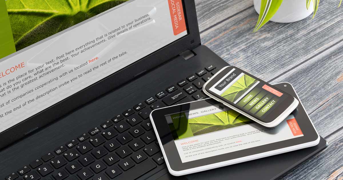 Laptop, tablet, and mobile device with the same website shown on all three screens.