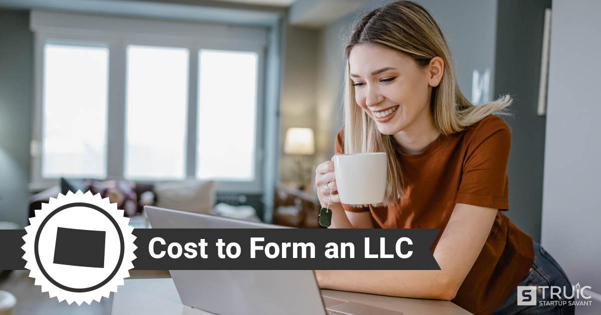 Woman smiling and drinking coffee after forming an LLC.
