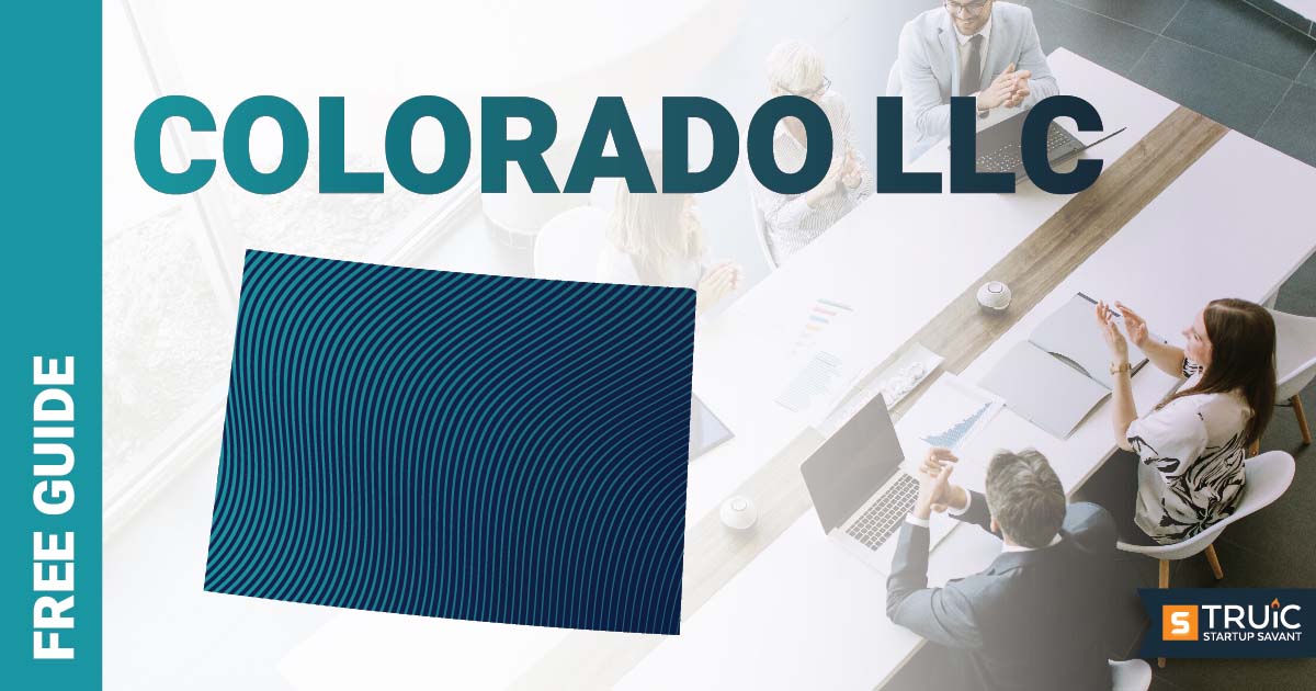 Woman sitting at her desk using her laptop to start an L L C in Colorado.
