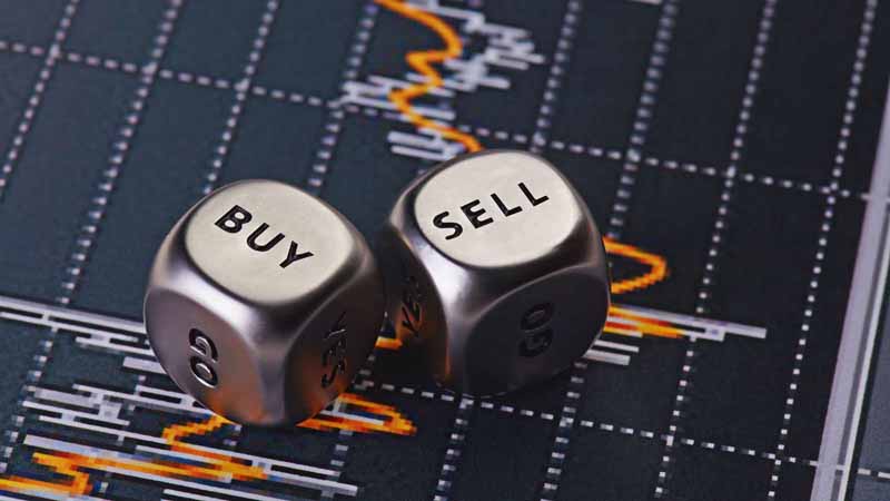 "Buy" and "Sell" dice on a financial chart.