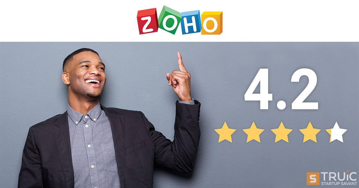 Smiling businessman next to 4.2 stars and pointing at Zoho logo.