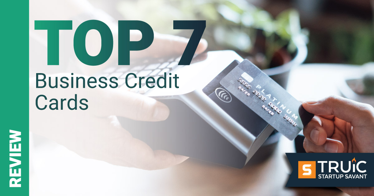 Smiling businesswoman with ribbon that says "Top 7 Business Credit Cards."